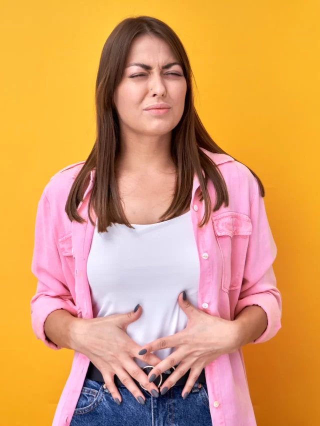 brunette-woman-puts-hands-stomach-feels-pain-medical-gynecological-health-problems-isolated-yellow-background (1)