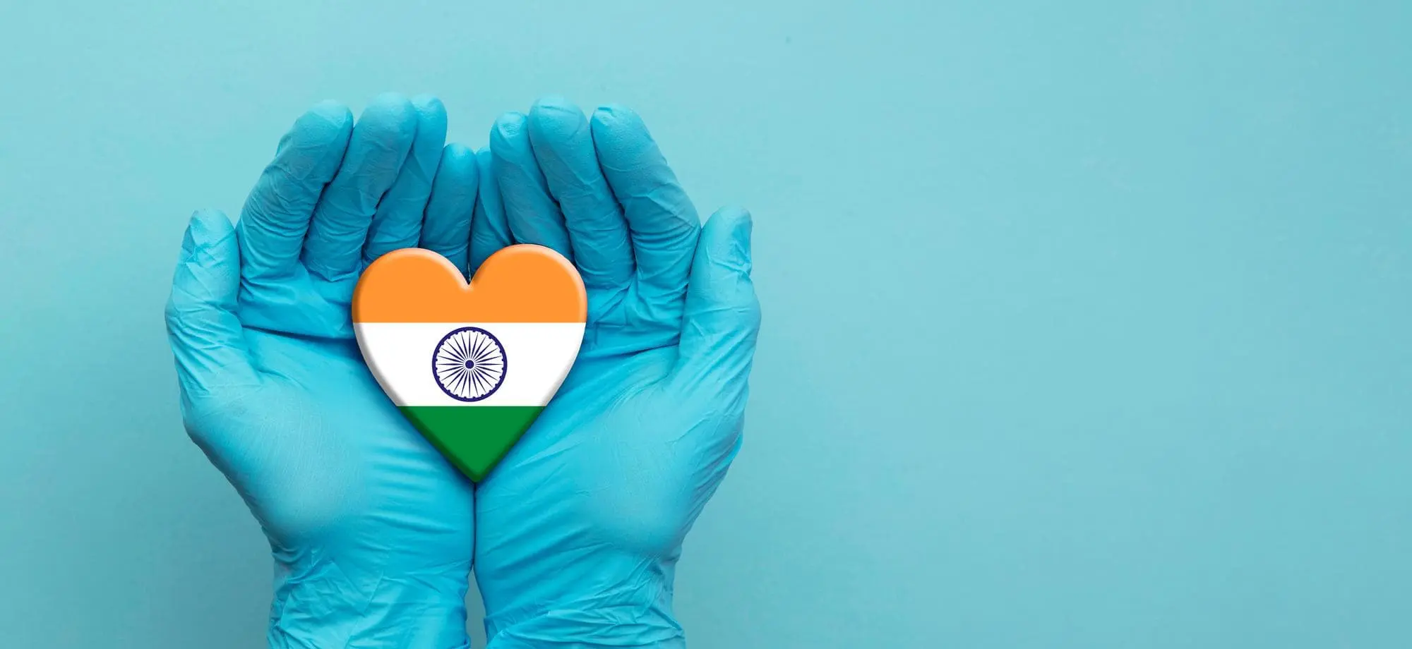 Indian flag printed on heart held between joined hands